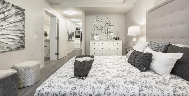 Contemporary 1 bedroom + den suite showcasing a luminous bedroom with up-to-date design elements