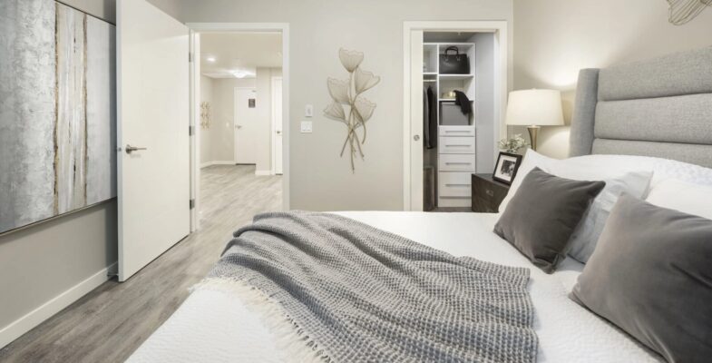 Spacious 1-bedroom suite bedroom in Calgary, illuminated by natural light, perfect for seniors seeking independent living apartments and aging in place communities in Alberta
