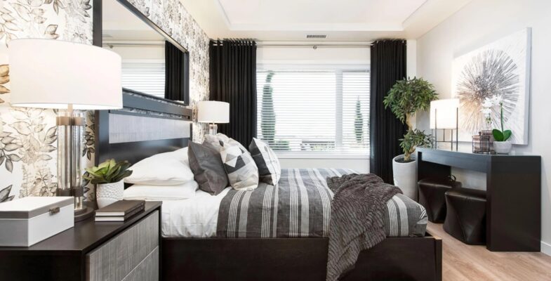 Elegant and contemporary bedroom design, featuring a monochromatic color scheme with floral wallpaper accents, contrasting black and white decor, and a stylish bedside setup complemented by modern art.
