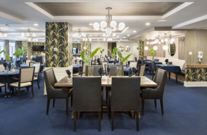 Elegant dining setup at Alvin's Jazz Club in Westman Village, featuring tropical-themed wall accents, sophisticated lighting fixtures, and well-appointed tables