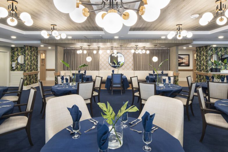 Stylish dining room with blue tablecloths, modern lighting fixtures, and elegant decor.